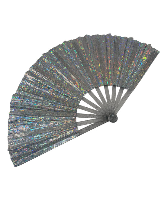 A silver glitter folding hand fan with iridescent holographic shimmer, shown partially open against a neutral gray background.
