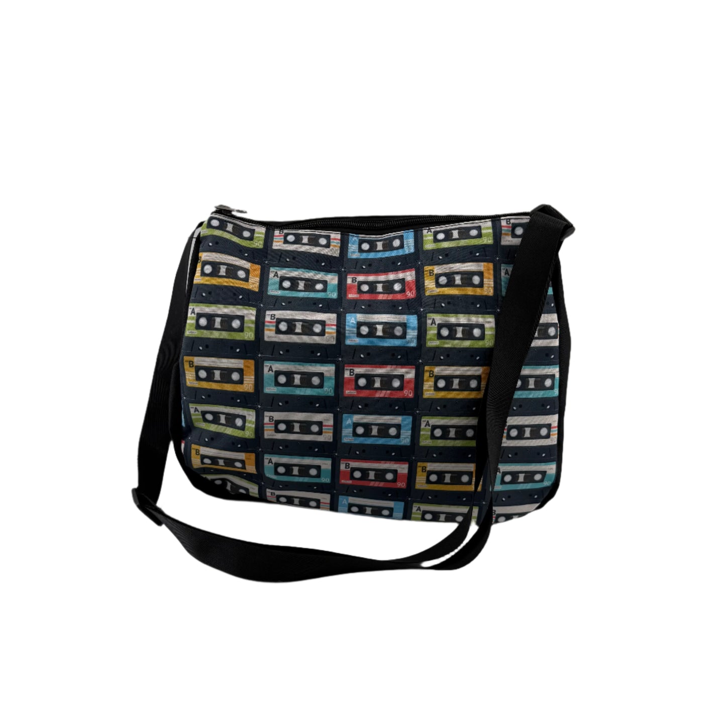 Retro cassette tape print shoulder bag with adjustable black strap, featuring colourful vintage cassette graphics, perfect for music lovers and festival style