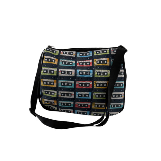 Retro cassette tape print shoulder bag with adjustable black strap, featuring colourful vintage cassette graphics, perfect for music lovers and festival style