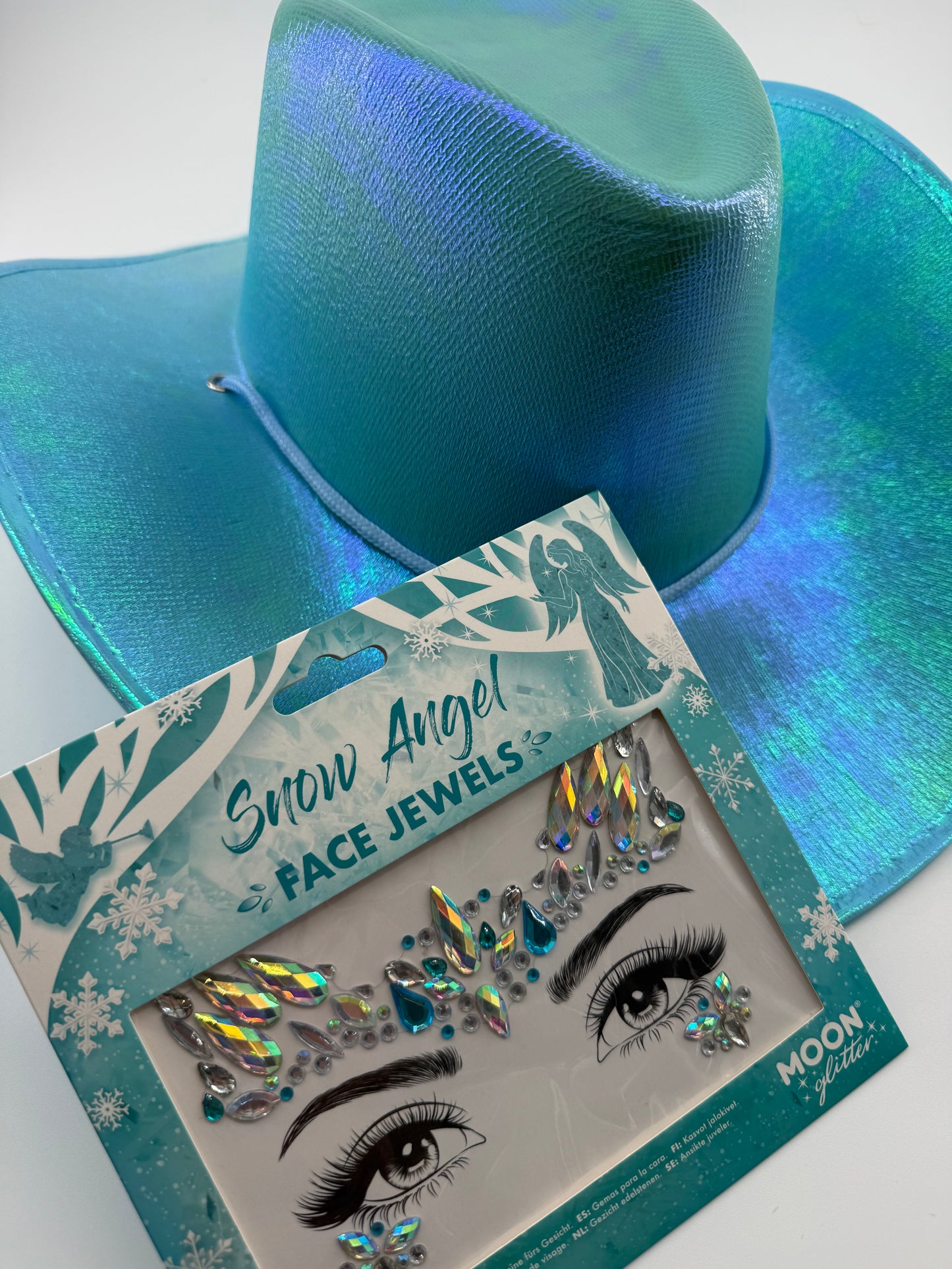 Package of snow angel face jewels in Blue with matching blue iridescent cowboy hat