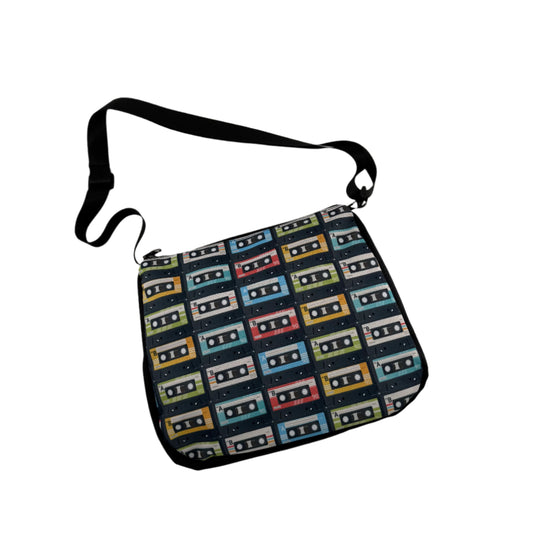 A multicolored retro cassette-themed shoulder bag with a geometric pattern of cassette tapes.