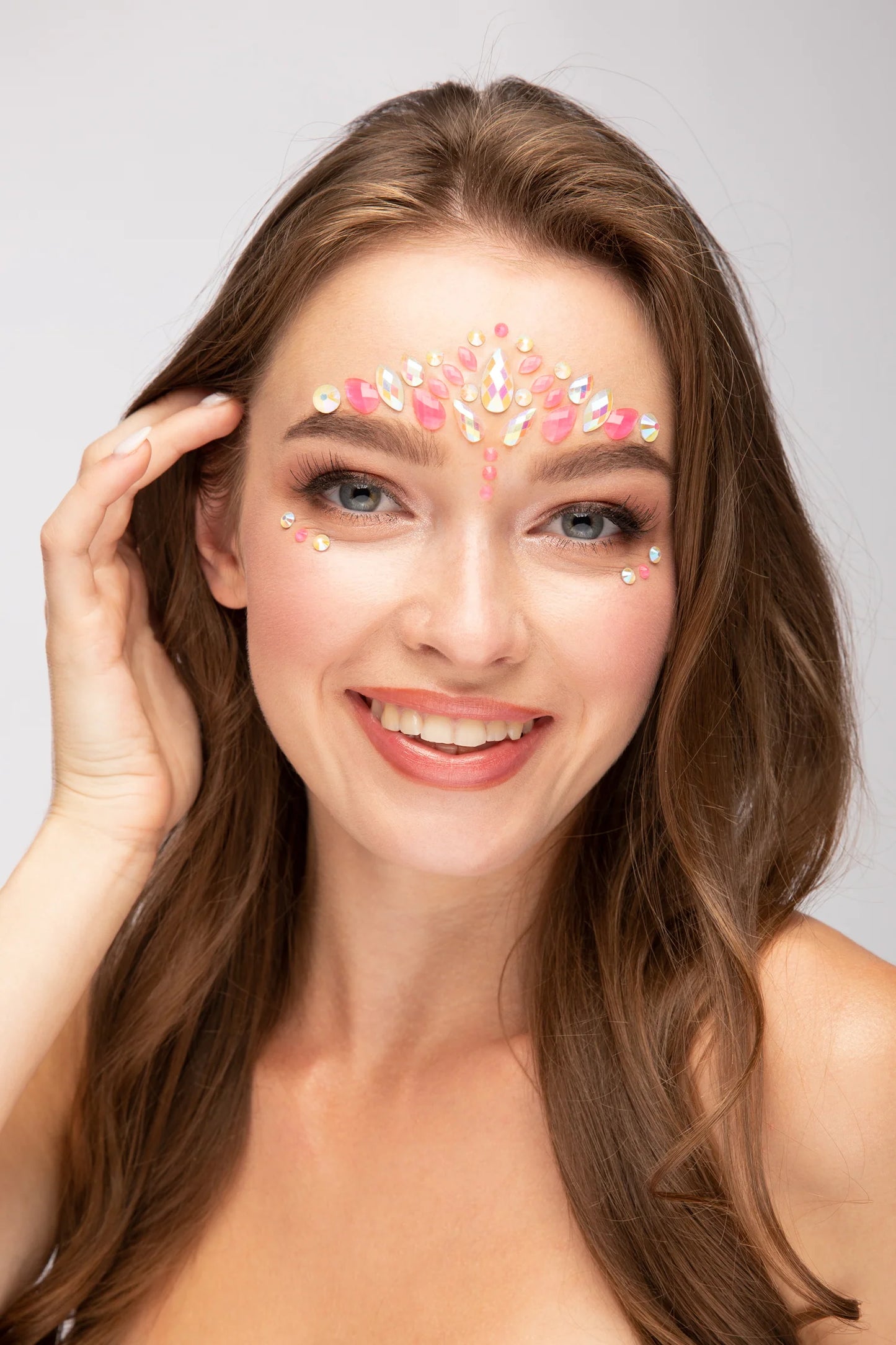 pink flamingo face jewels glow in the dark, pink flamingo glow in the dark gems worn by a model on a grey background