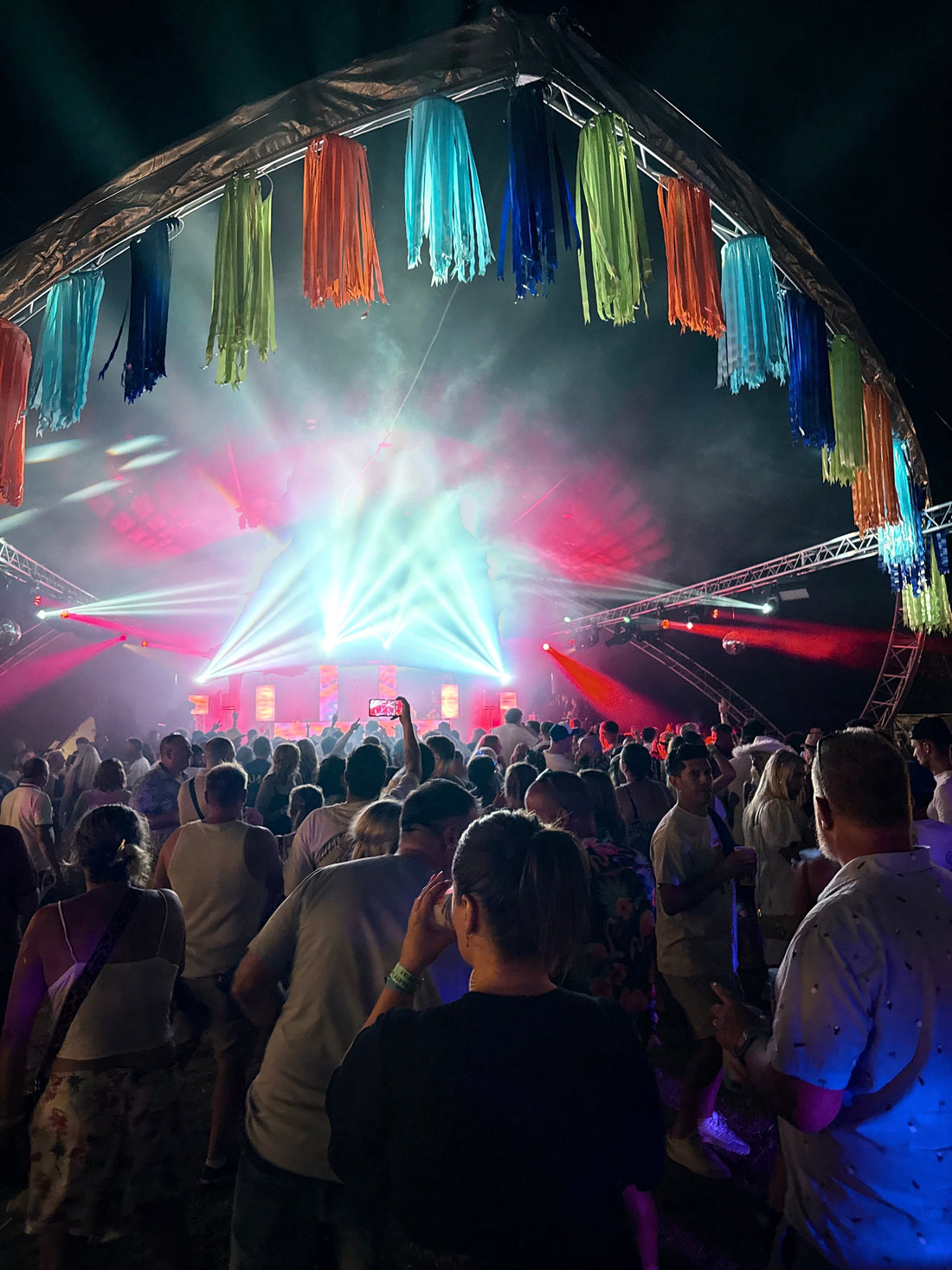 people dancing outdoors at a music festival