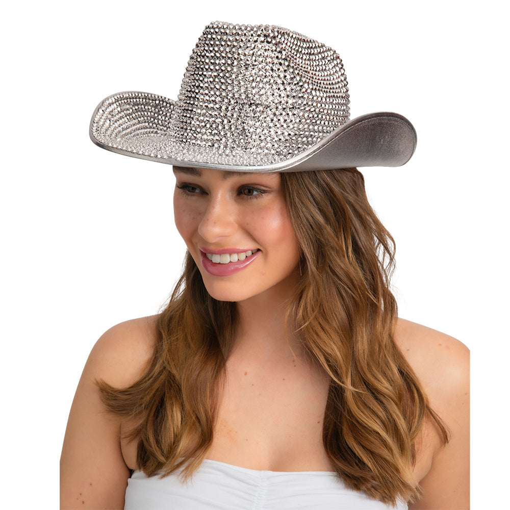 Woman wearing a sparkling silver cowboy hat on a white background