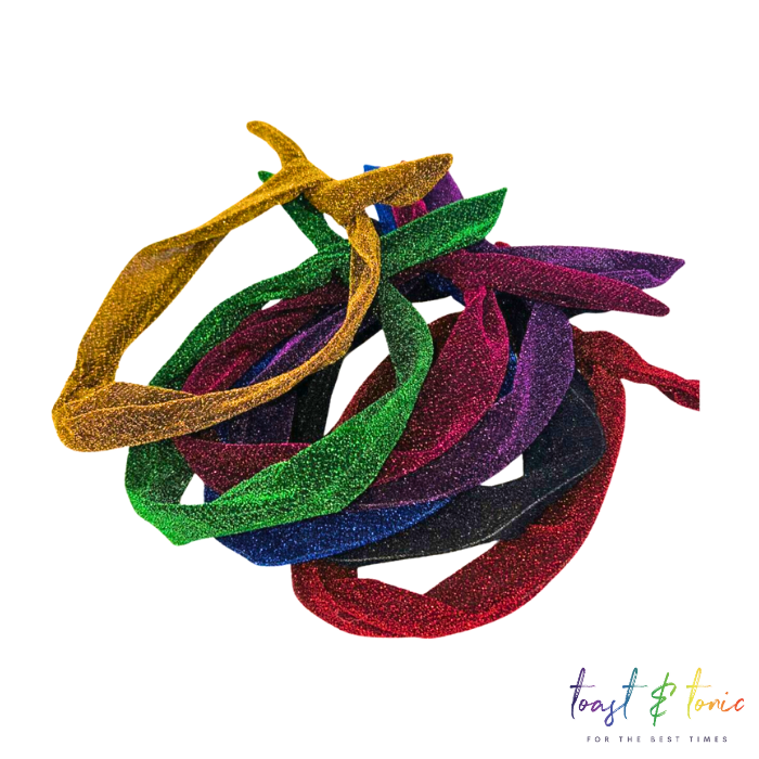 A collection of glittery wired headbands in various colors including gold, green, red, pink, black and purple.